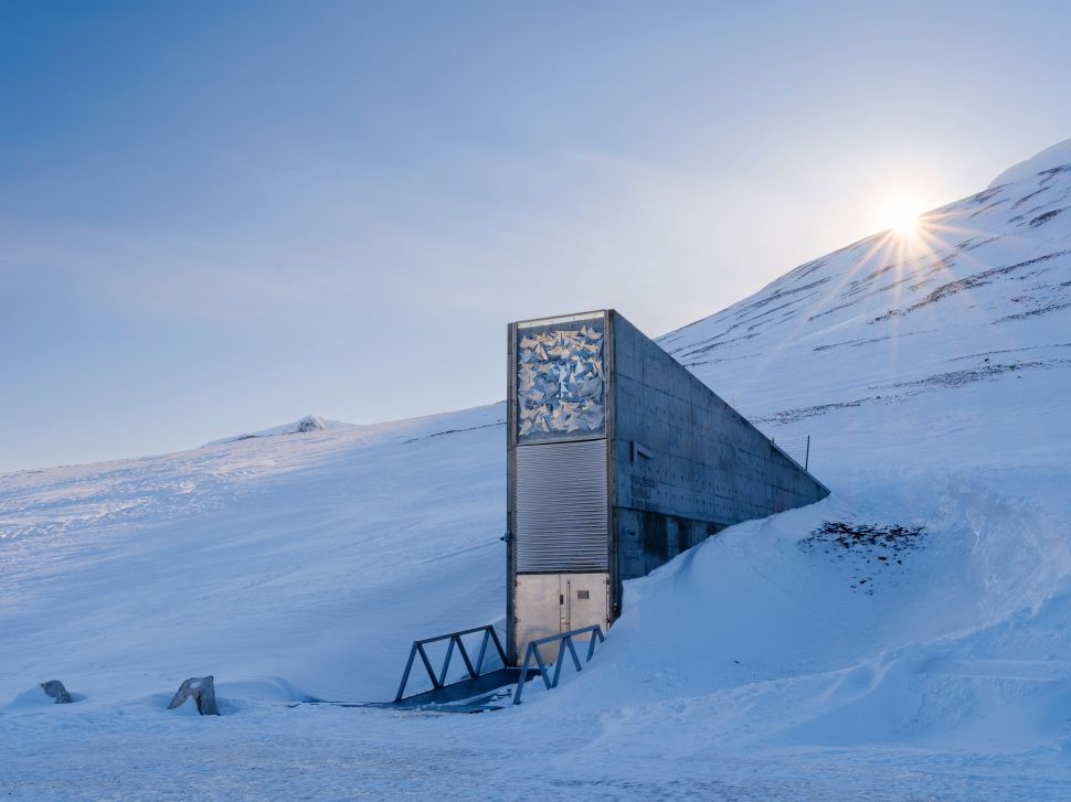 Small rectangular building coming out of snowy hill