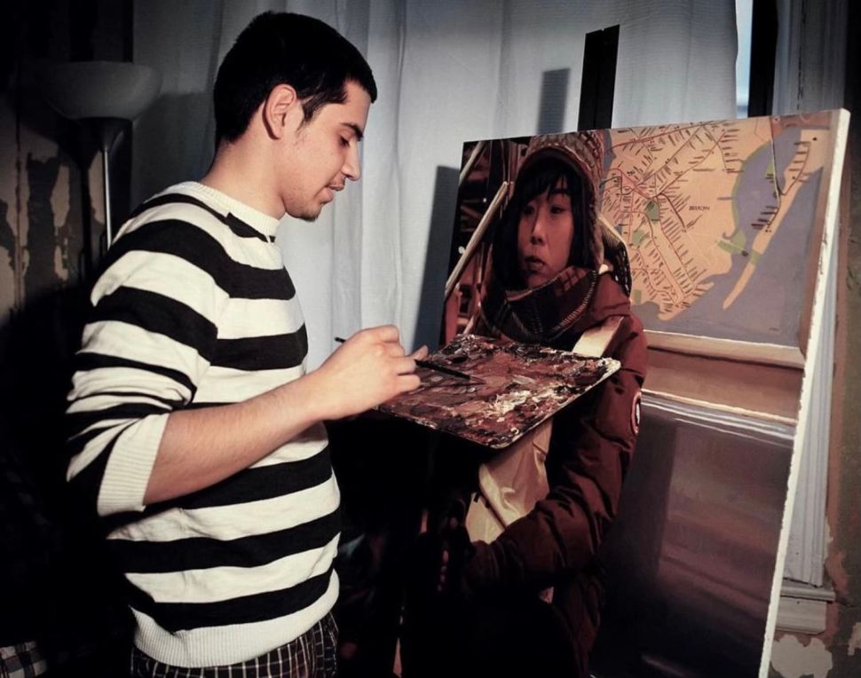 Devon Rodriguez poses beside a painting portraying a person on the subway.